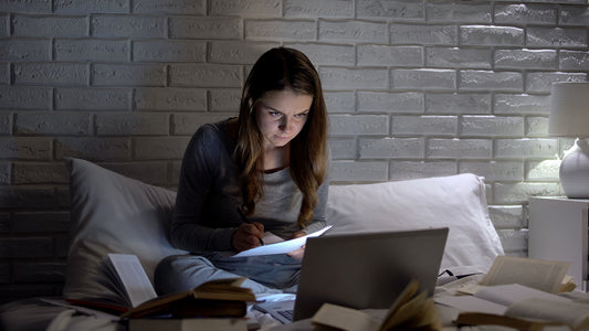 College student trying to nap in a dorm room with shared space Student using eye mask and noise machine to sleep during the day Chart showing how lack of sleep affects GPA and focus